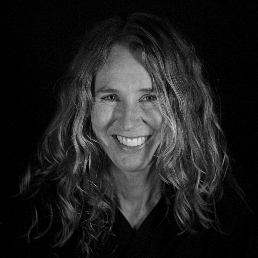 Black and white portrait of a woman smiling into the light